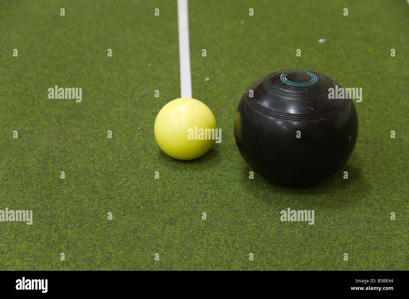 Bowl and jack on an indoor bowls carpet Stock Photo