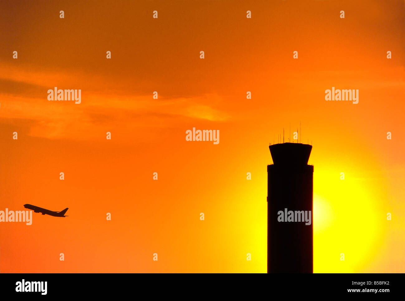Sun sets behind airport control tower, Orlando International Airport 