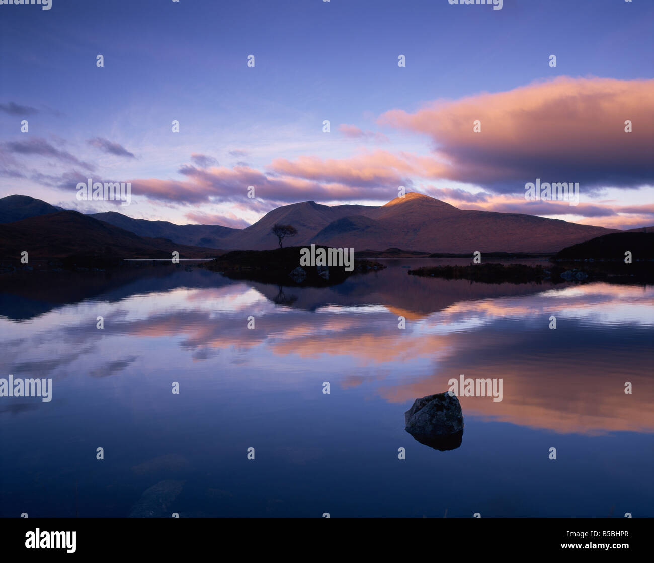 Reflections in Loch Achlaise of clouds and dark hills of Rannoch Moor, in the Highland Region of Scotland, United Kingdom Stock Photo