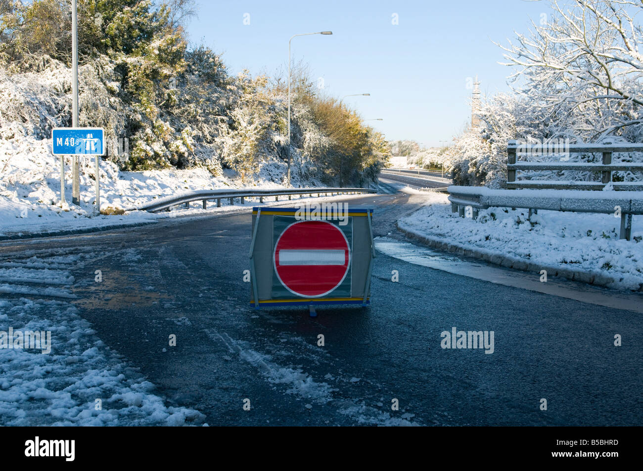 Closed motorway slip road in the snow due to an accident no entry sign in the foreground Stock Photo