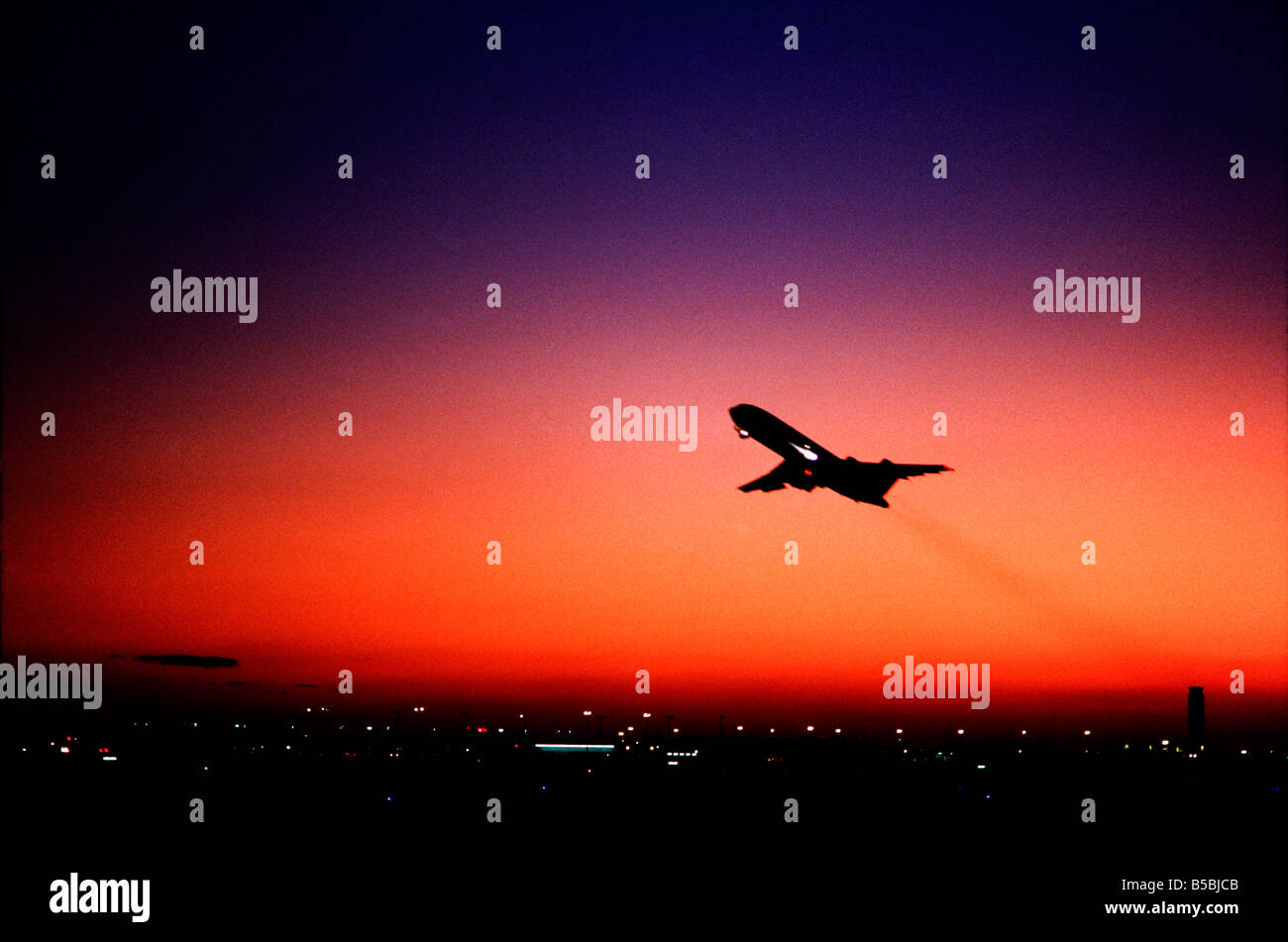 Commercial Airliner takeoff at dusk, over airport, Miami International Airport Stock Photo