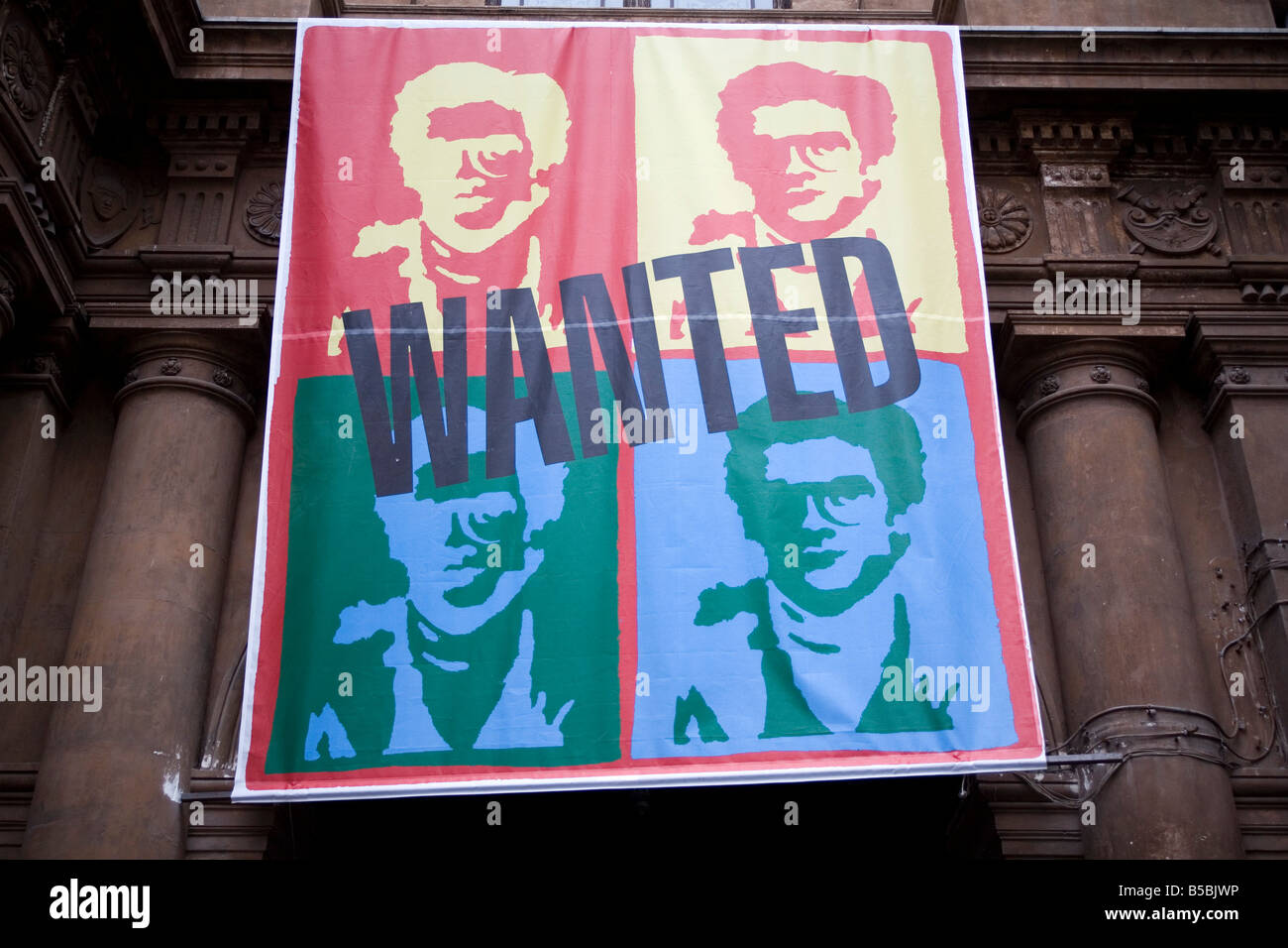 Andy Warhol style banner featuring the face of wanted mob boss Matteo Messina Denaro hanging from the window of Bellini Theatre Stock Photo