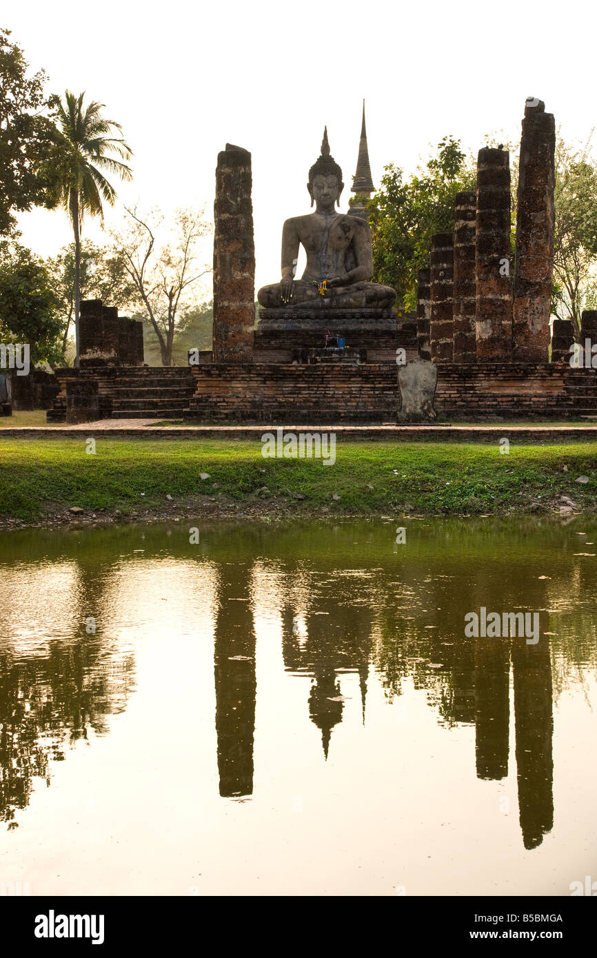 Buddha Statue in Wat Mahathat Temple in Sukhothai Historical park at sunset Thailand Stock Photo