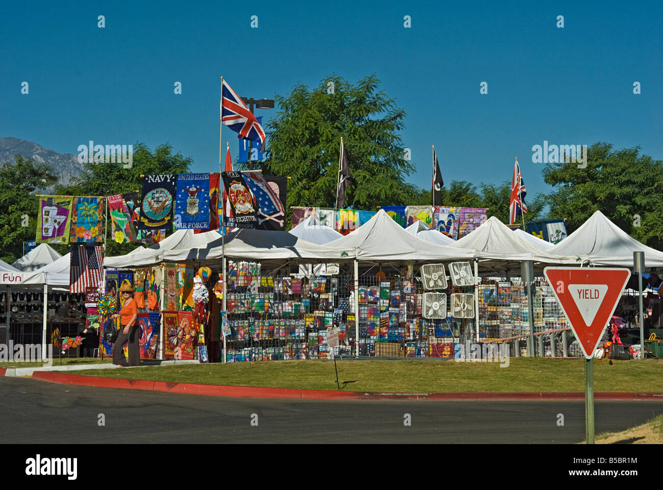 College of the Desert Street Fair swap meet 300 vendors offering a wide variety of unique gifts flags banners Fred Waring Drive Stock Photo