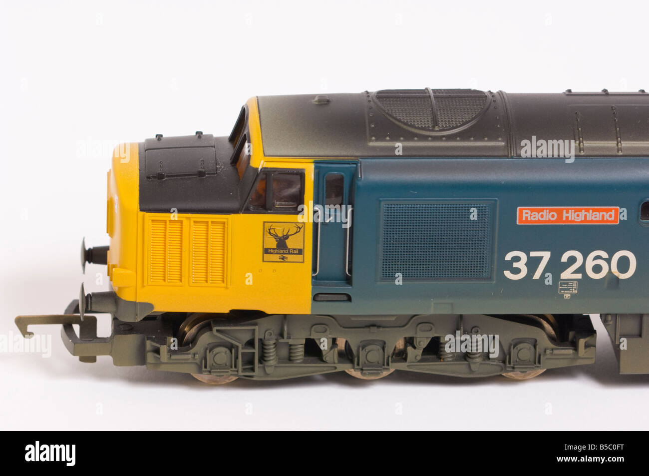 Close up of a  Hornby electric class 37 diesel model train in blue and yellow livery shot against a white background (cut out) Stock Photo