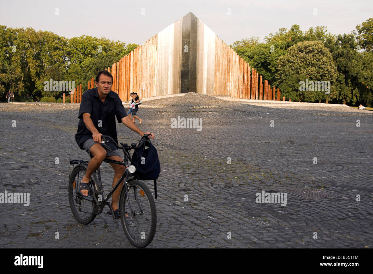 Man on a bicycle, Monument to 1956 Hungarian Revolution, Pest, Budapest, Hungary Stock Photo