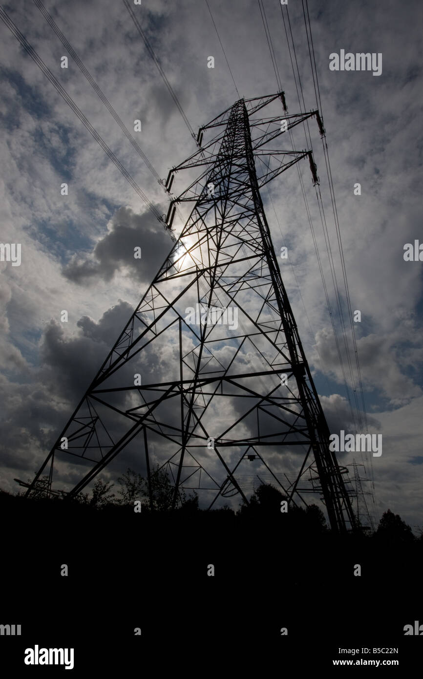 UK Electricity Pylon, silhouetted against a cloudy sky Stock Photo - Alamy