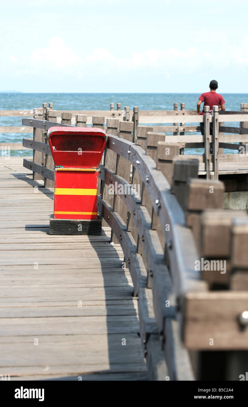 a trash bin and a young man stand alone back to back Stock Photo - Alamy