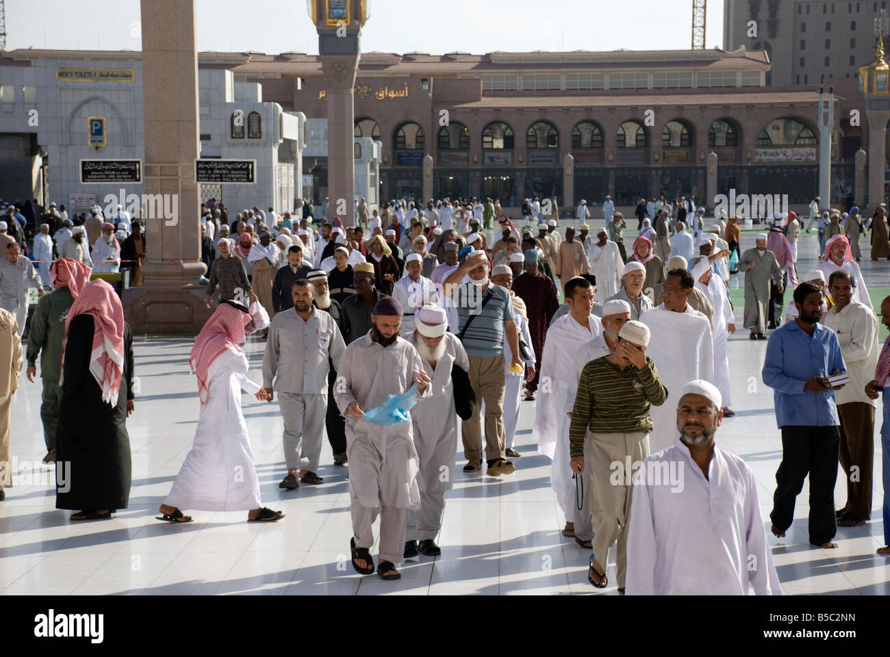 People arriving one of the gates of Masjid al Nabawi to offer their prayers in Madinah Saudi Arabia Stock Photo