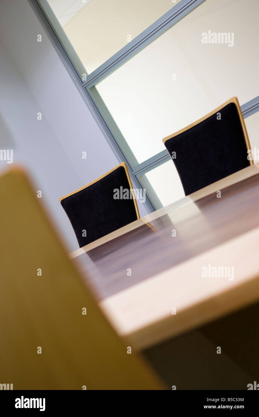 THREE CHAIRS IN AN EMPTY BOARDROOM Stock Photo
