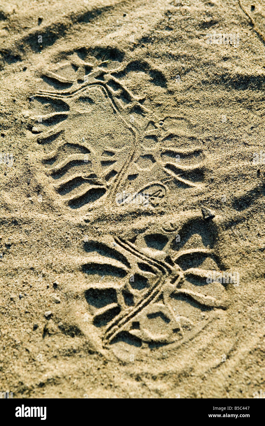 an impression of a boot sole in the dirt Stock Photo