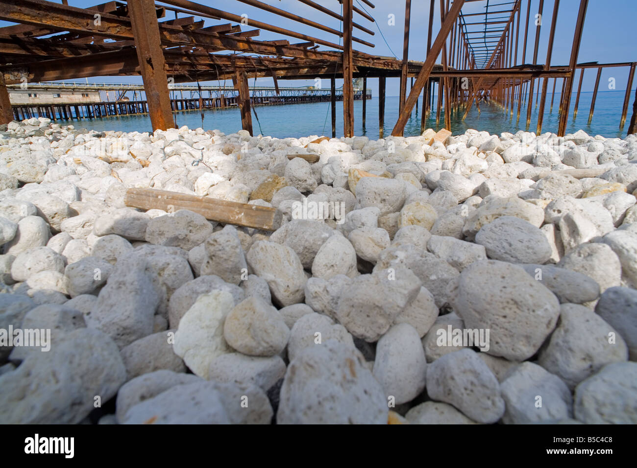 White pumice stones and rusted piers at the pumice quarries at Lipari Island Stock Photo