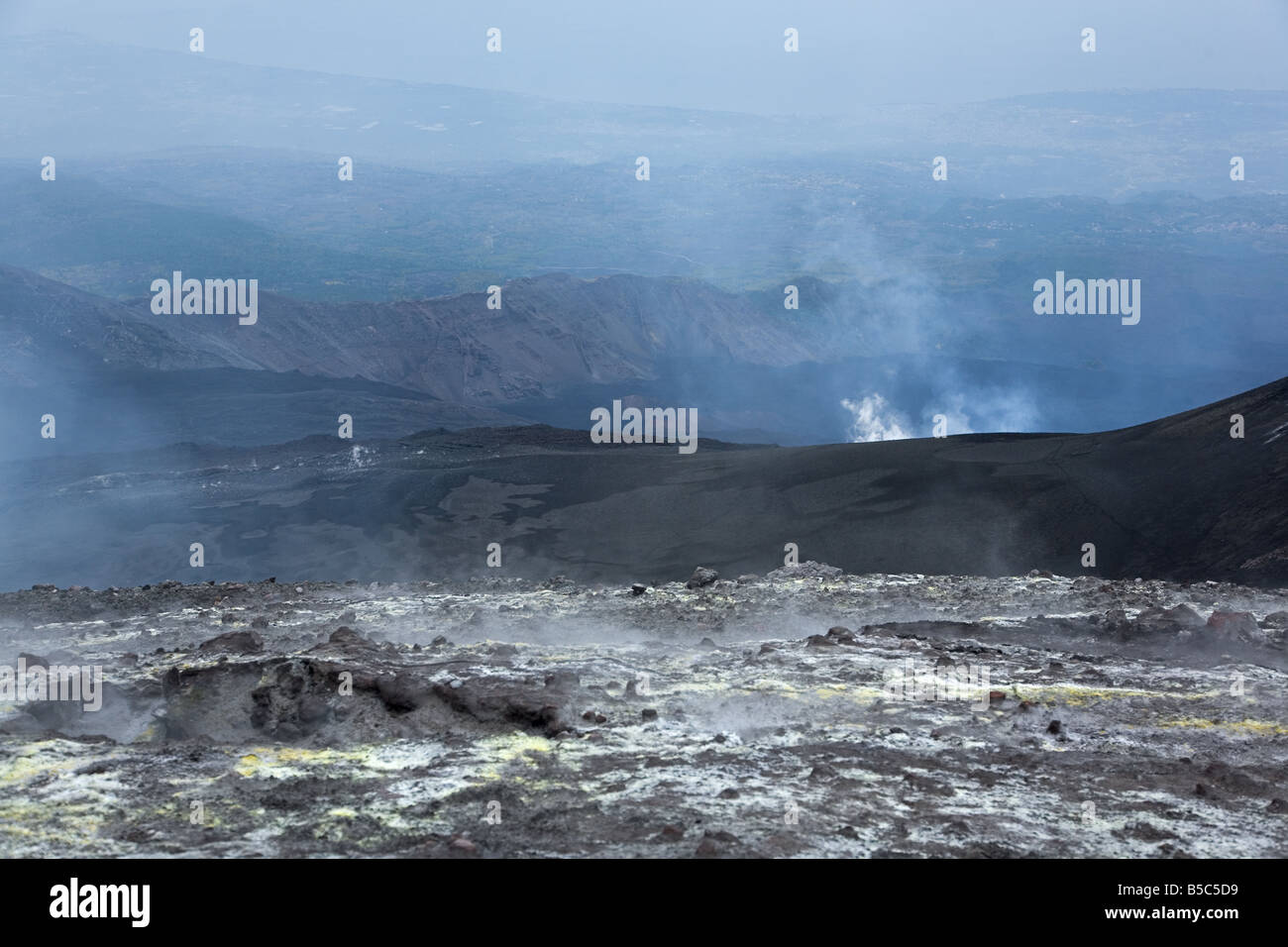 View down into Valle del Bove from the upper flanks of Mt. Etna volcano, smoke from the active eruptive fissure in the centre. Stock Photo