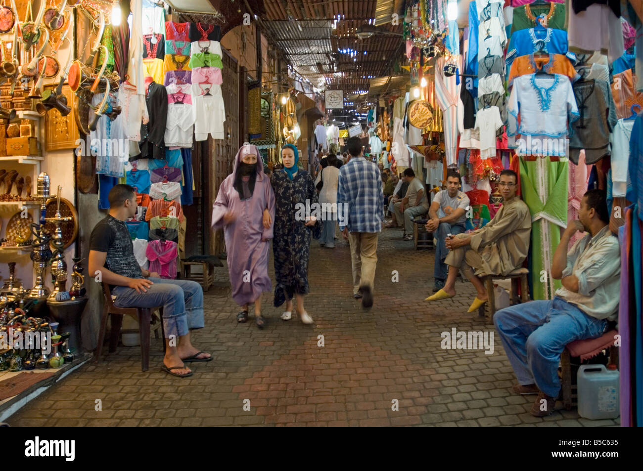 A view of local people shopping in the narrow streets of the souk area in Marrakesh. Stock Photo