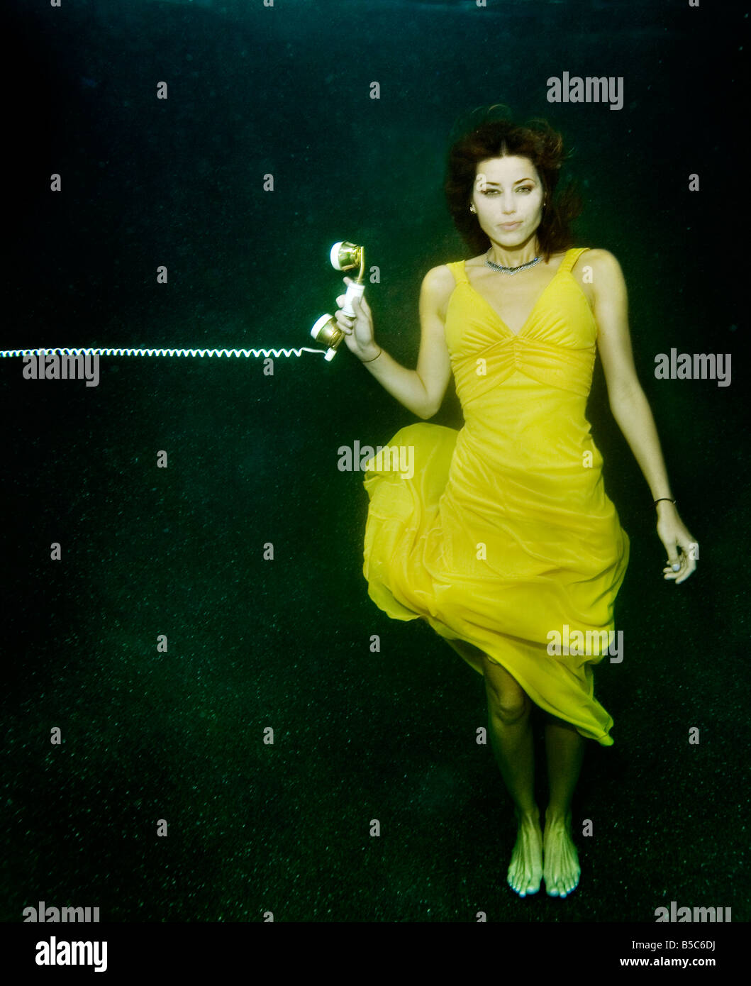 woman underwater with phone Stock Photo