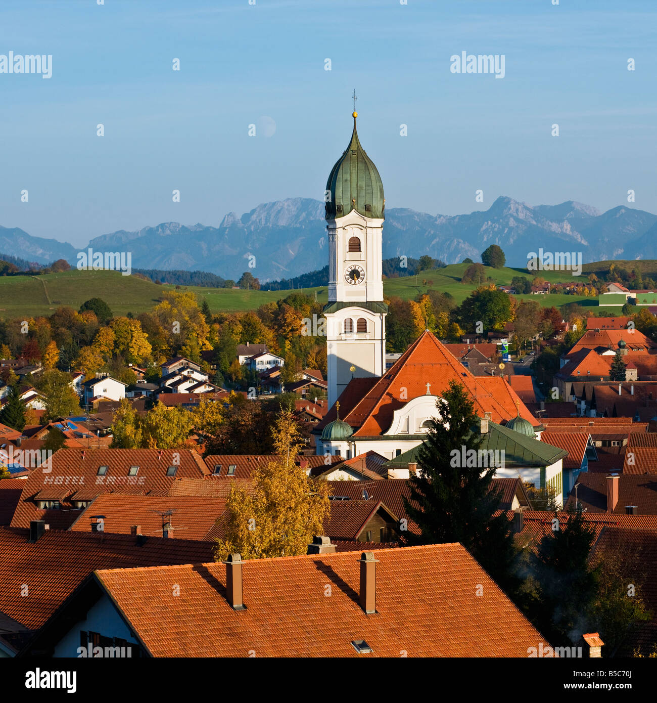 Tower of Saint Andreas Church and mountains of Allgaeu region, Nesselwang, Germany Stock Photo