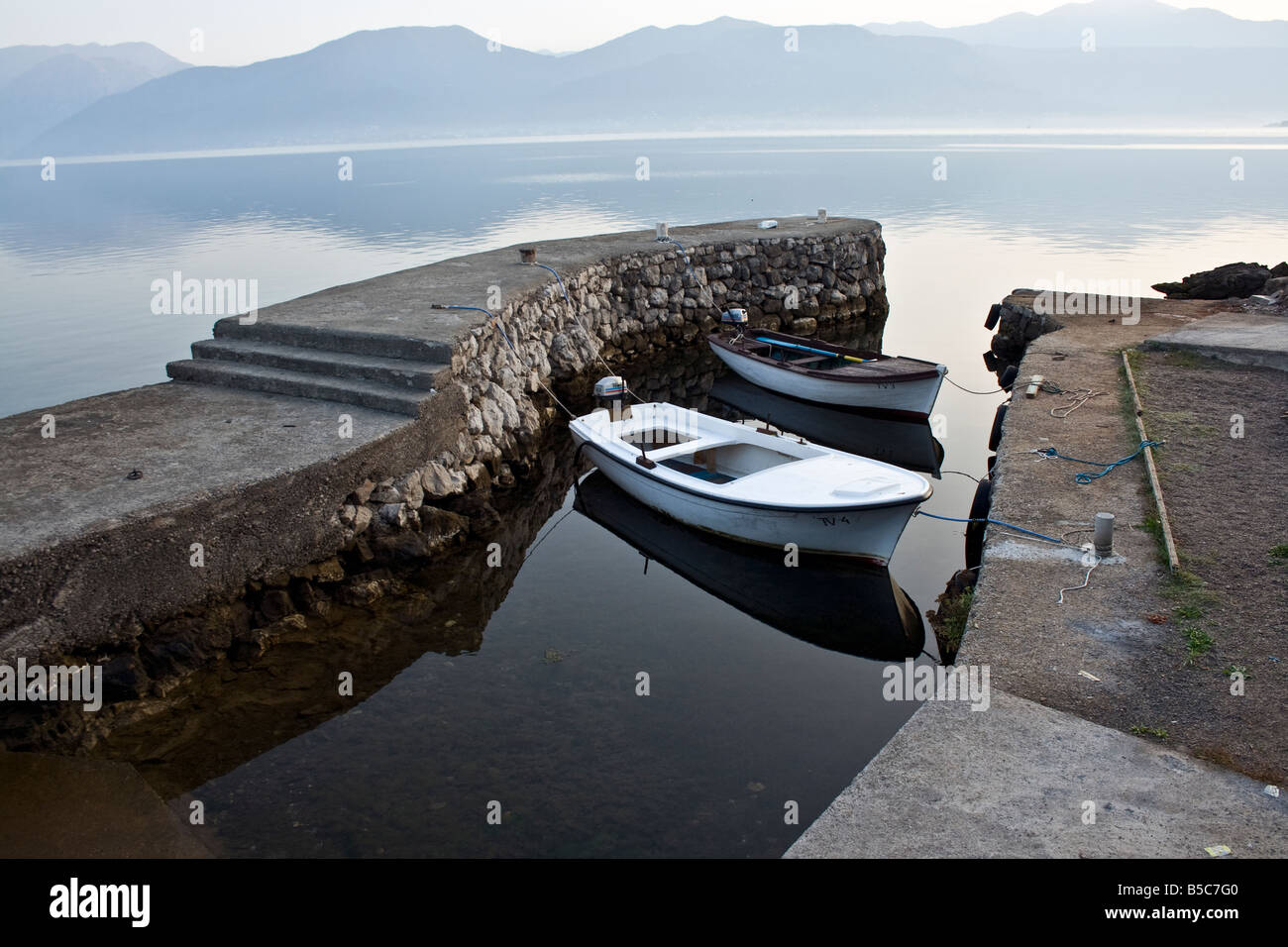 two wooden boats in a little bay in the morning, Kotor, Montenegro Stock Photo