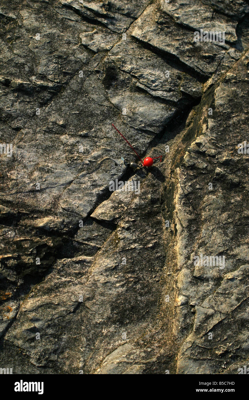Piece of fishing tackle caught in rock crevice Stock Photo