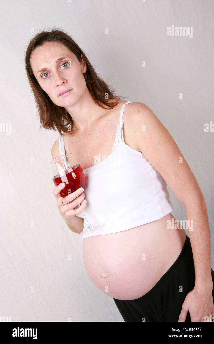 Heavily Pregnant Young Woman In Third Trimester At 32 Weeks Drinking Stock Photo Alamy