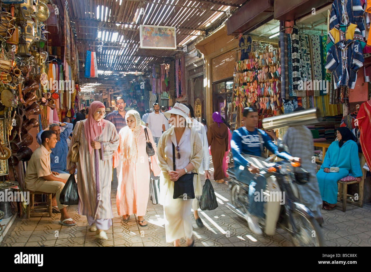 A view of people shopping in the narrow streets of the souk area in Marrakesh. Stock Photo