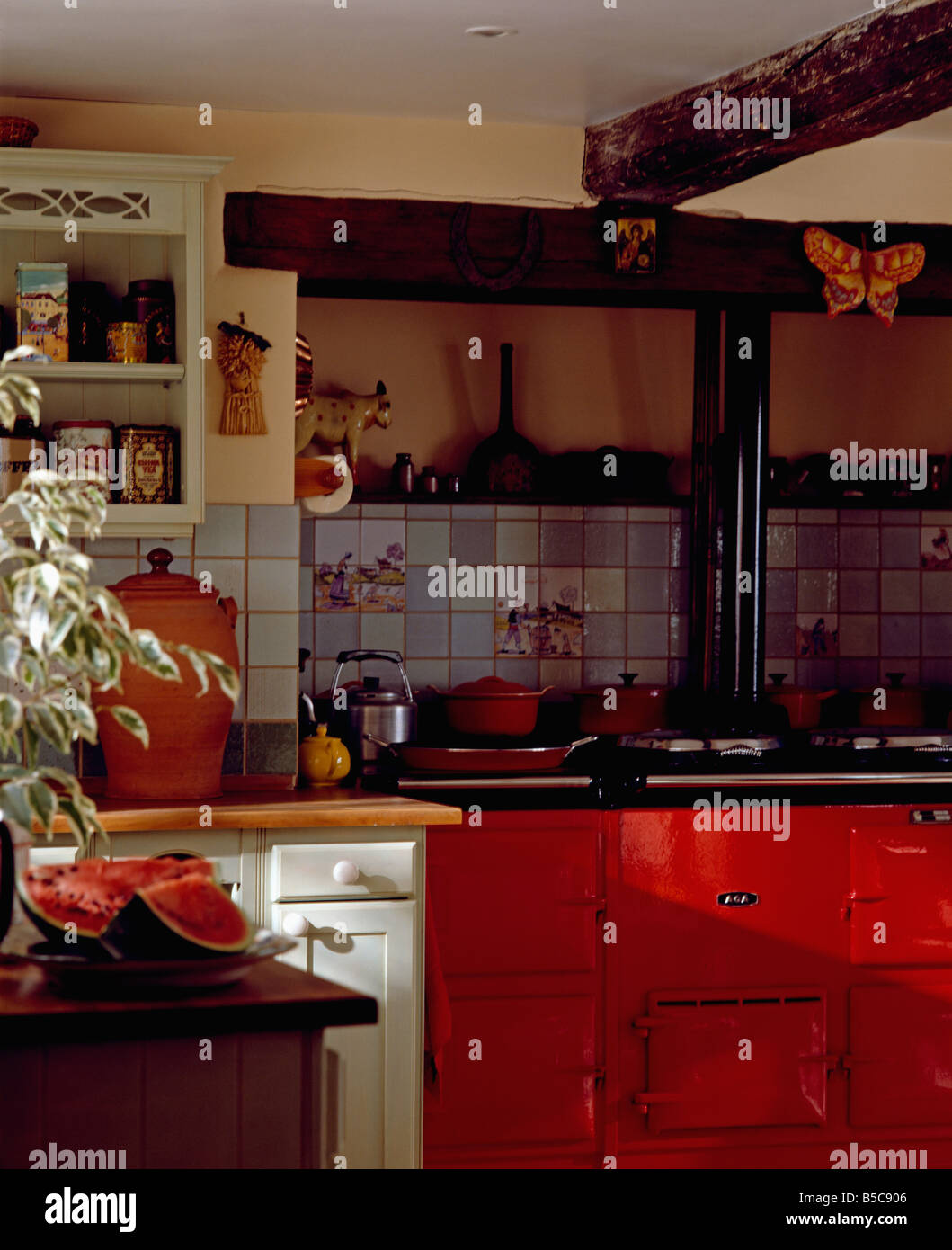 Double red Aga in cottage kitchen Stock Photo Alamy