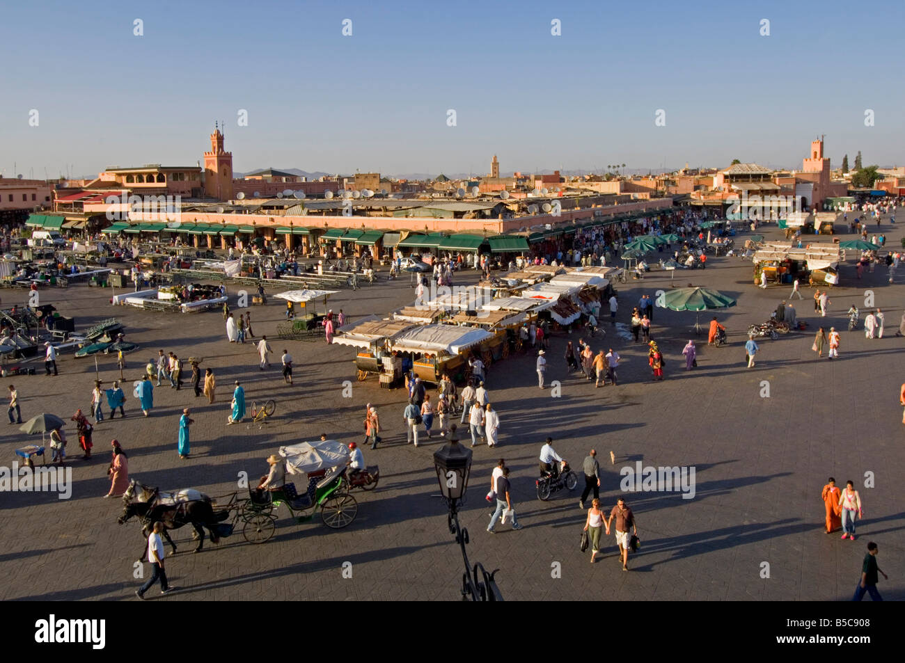 A wide aerial view of the Djemaa El Fna in Marrakesh as it starts to fill up in the late afternoon sun. Stock Photo