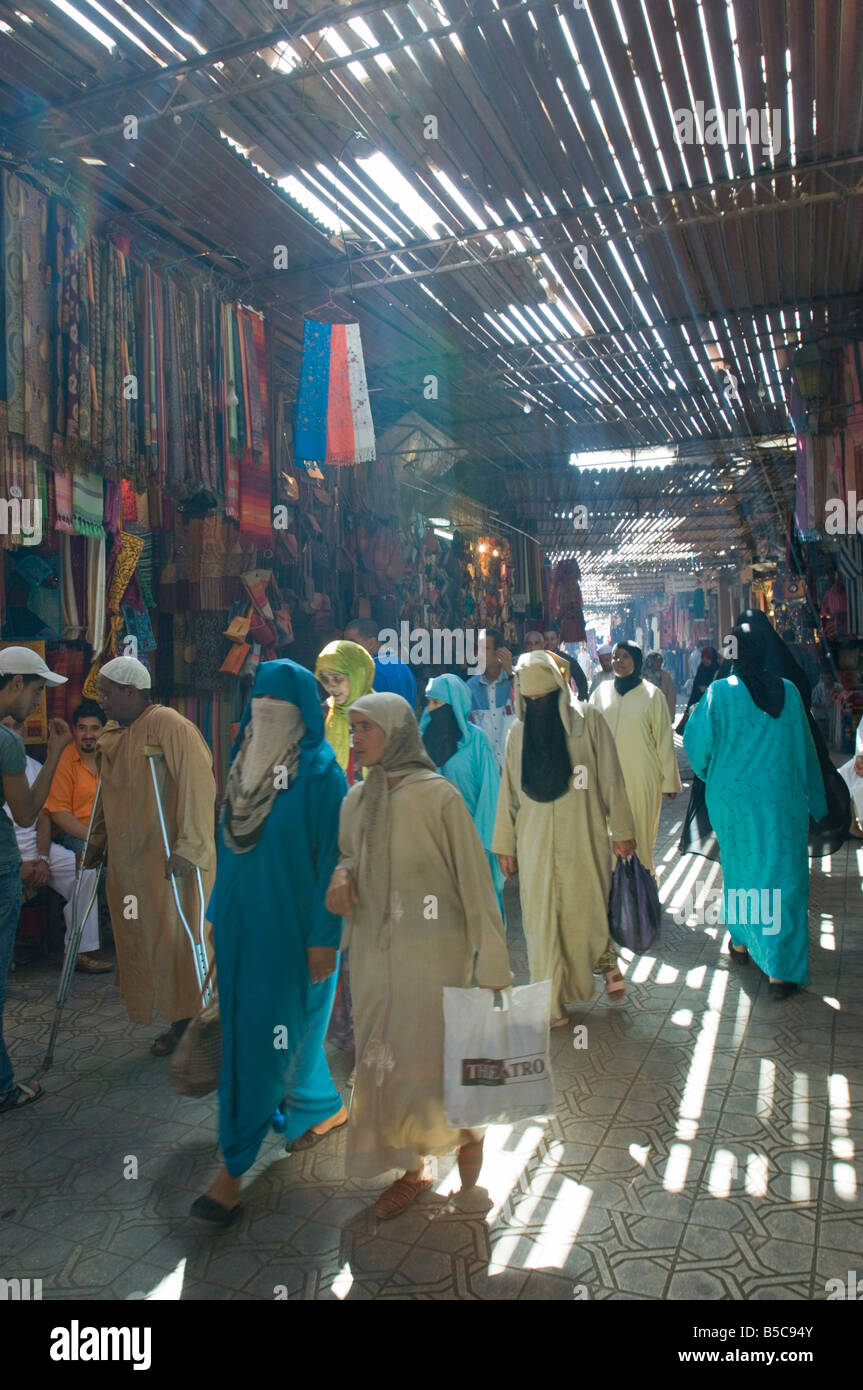 A view of local people shopping in the narrow streets of the souk area in Marrakesh. Stock Photo