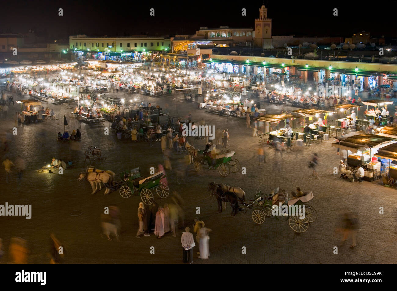 A wide angle aerial view of the busy Djemaa El Fna in Marrakesh at night with slow shutter speed for motion blur. Stock Photo