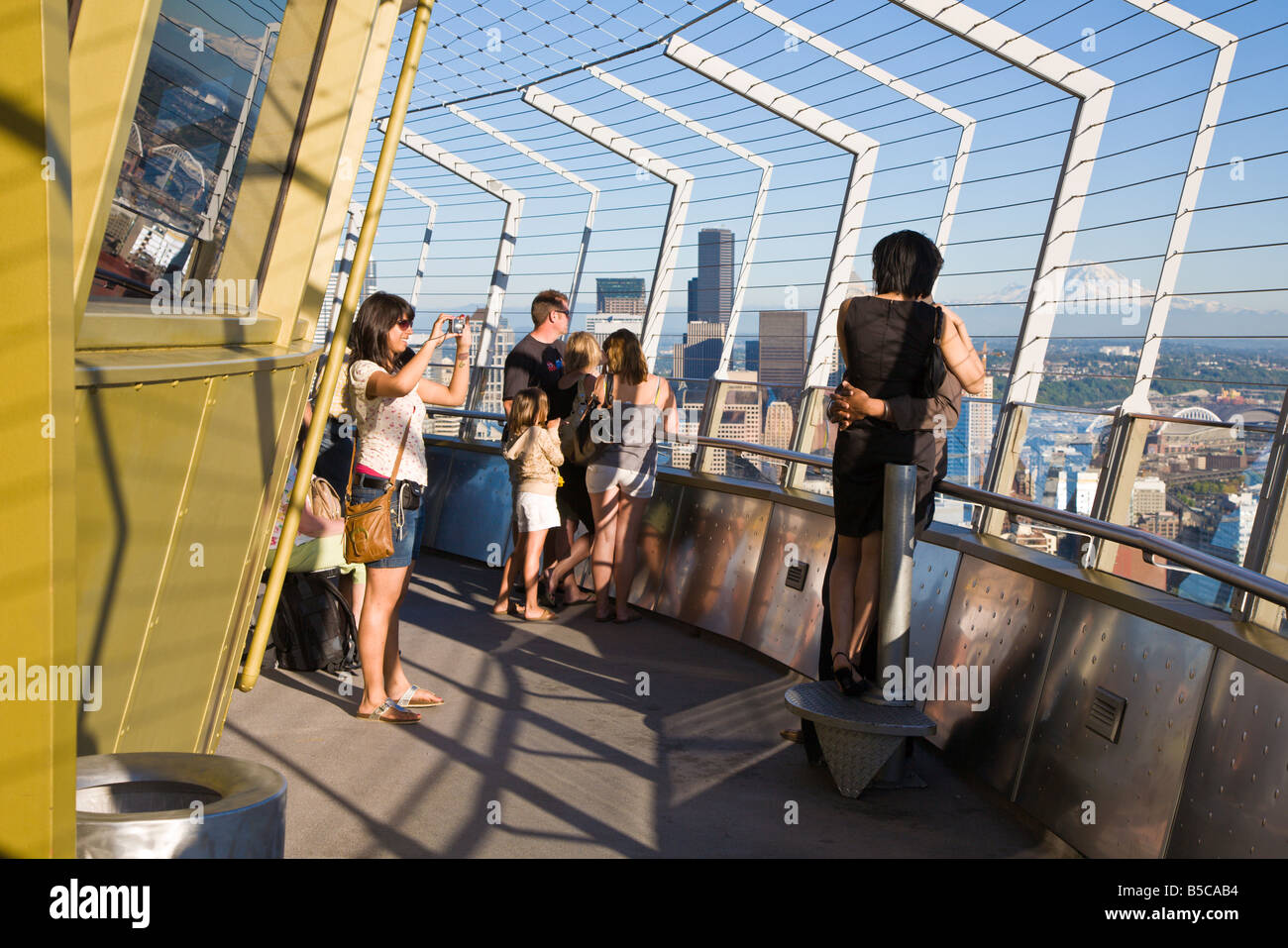 Couple is photographed over Seattle skyline on top of the Space Needle Stock Photo