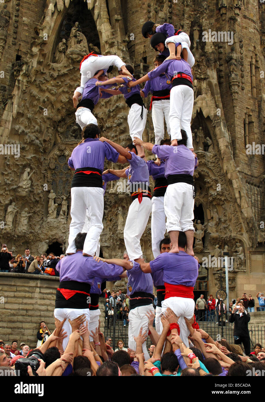 Castellers building human tower(castell) outside Gaudi's La Sagrada ...