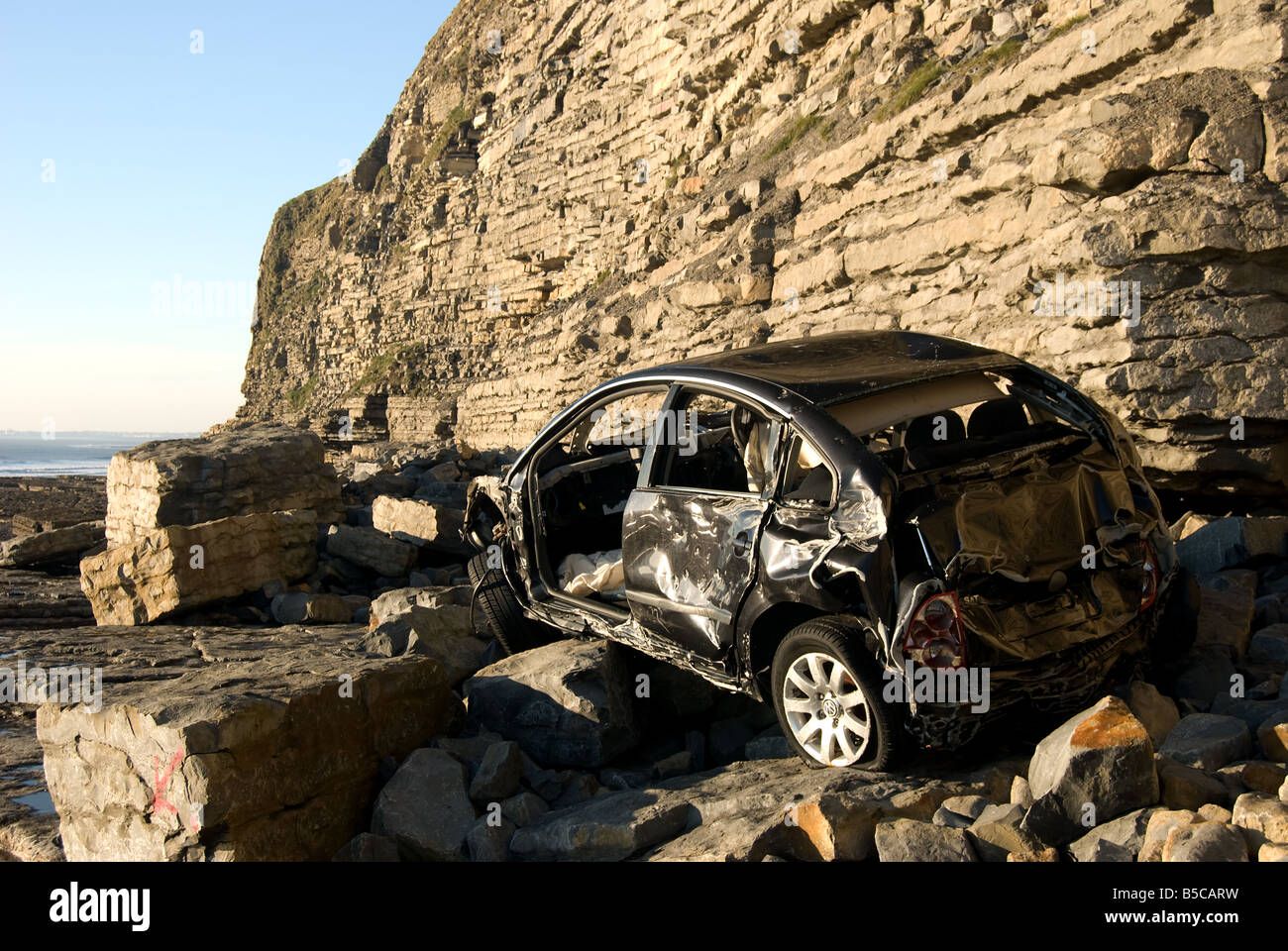Car wreckage on Southerndown Beach, Bridgend, South Wales Stock Photo
