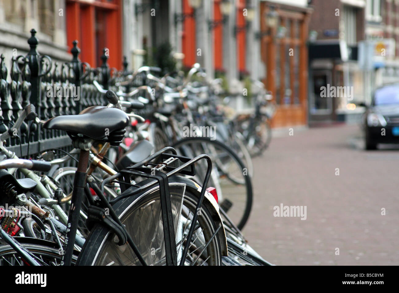 Bike bikes ride riding lock chaining metal fence sidewalk