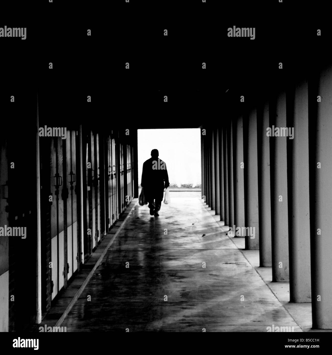 Man in corridor of housing block Stock Photo