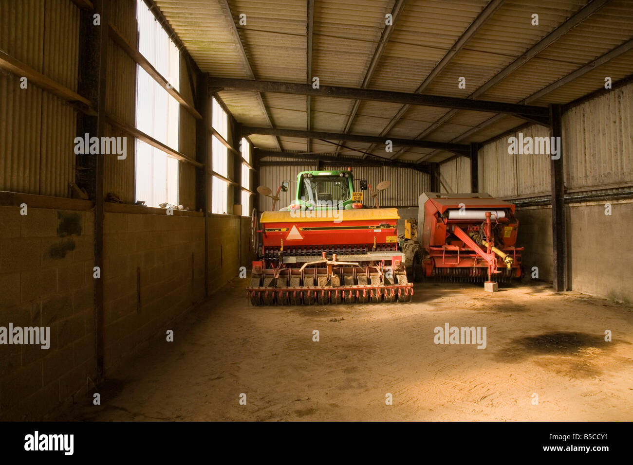 Farming vehicles in a shed Stock Photo