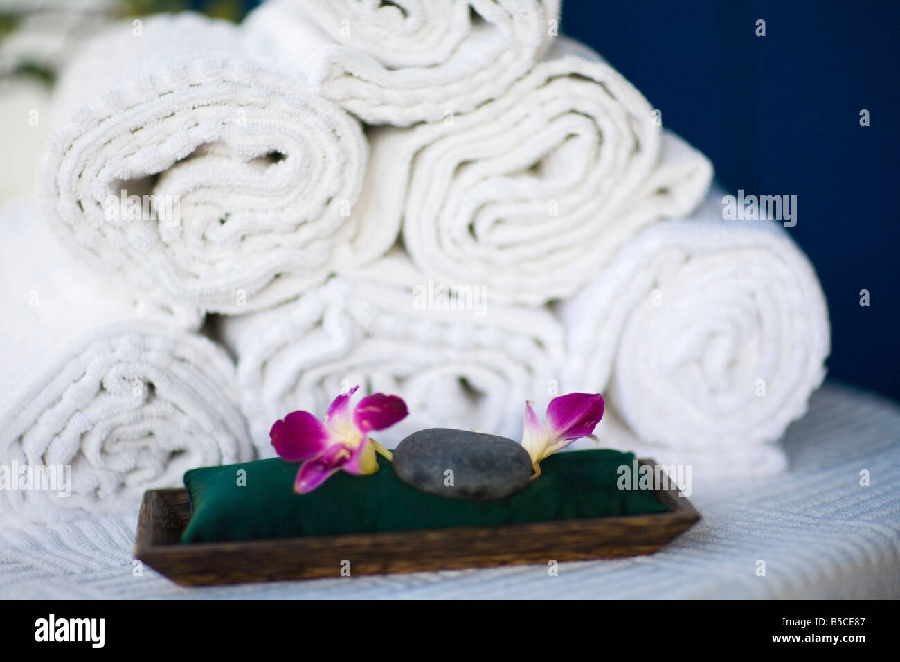 Rolled towels and spa rocks Stock Photo - Alamy
