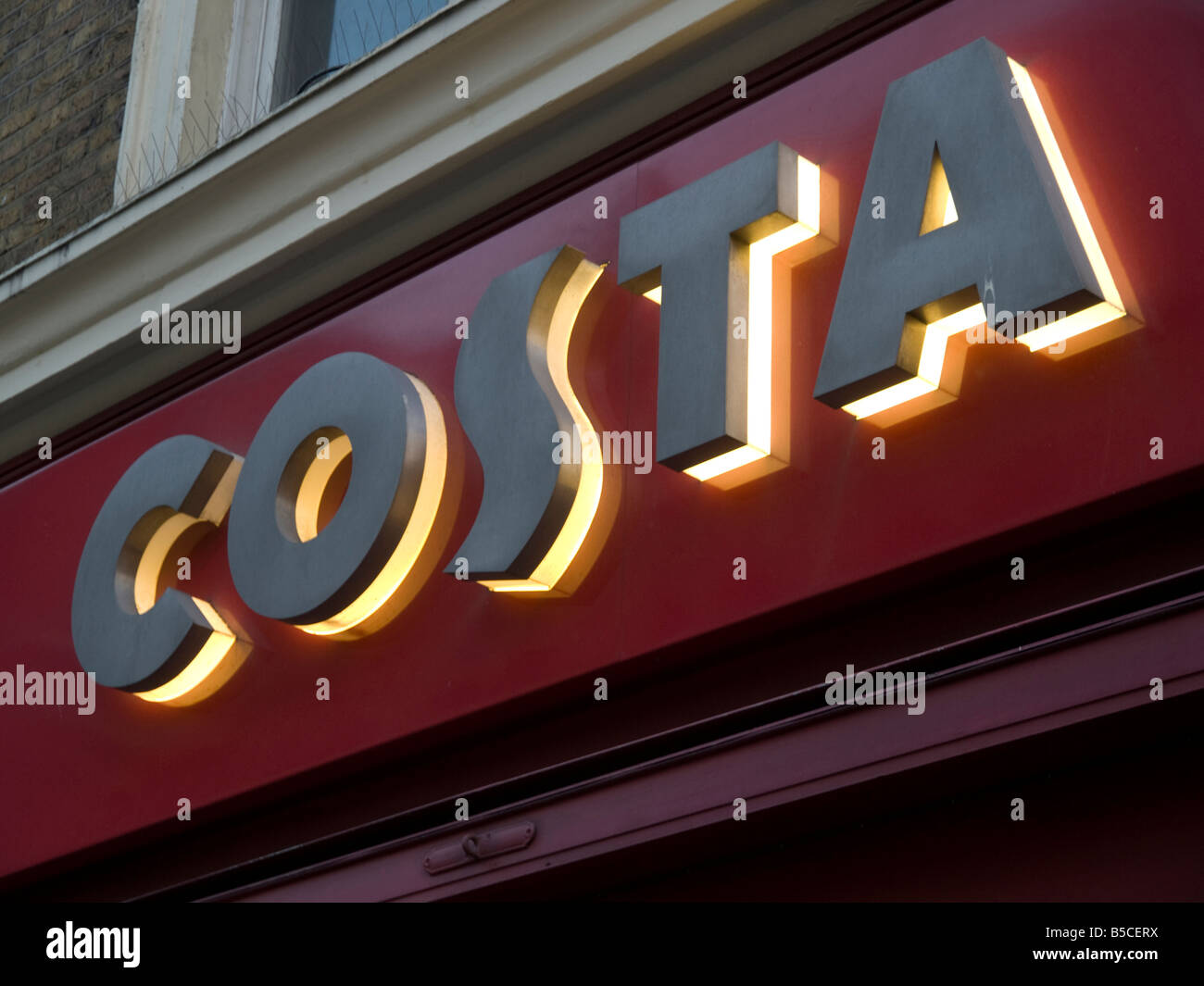 Illuminated Costa coffee shop sign Stock Photo