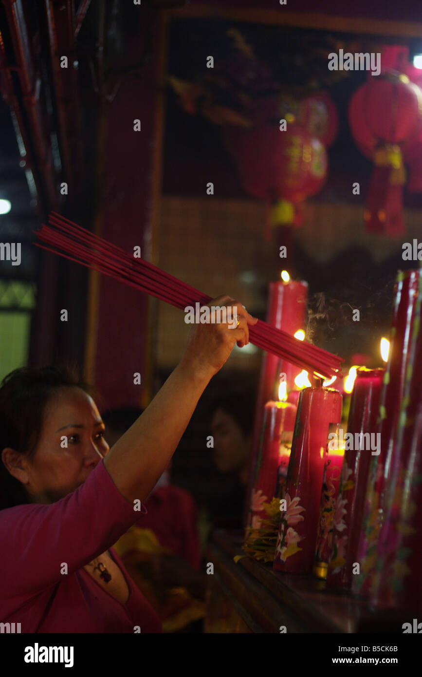 woman lights candles on [chinese new year] Stock Photo Alamy