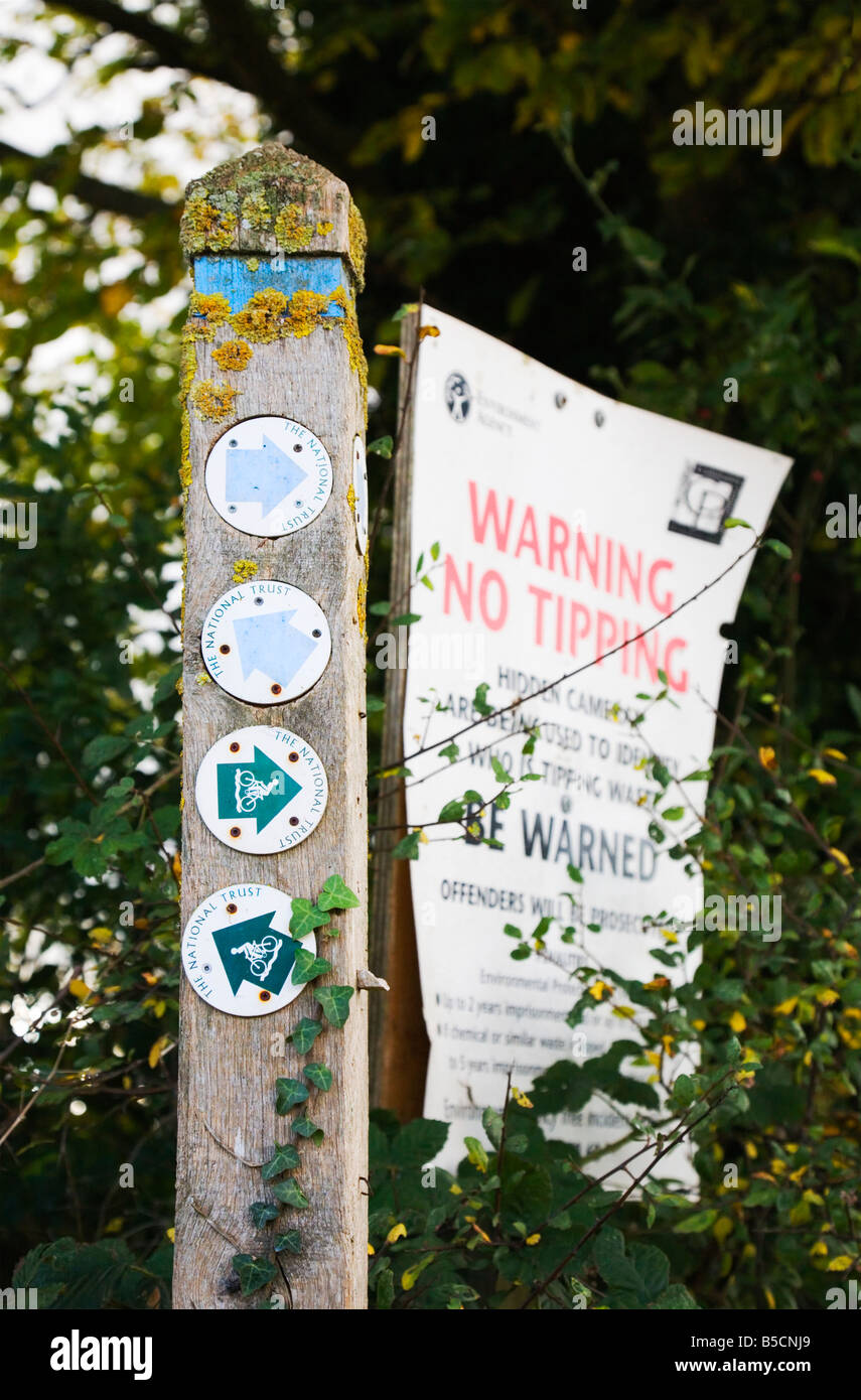 National Trust and Environmental Agency signs showing directions for cycle and walking paths and warnings against flytipping. UK Stock Photo