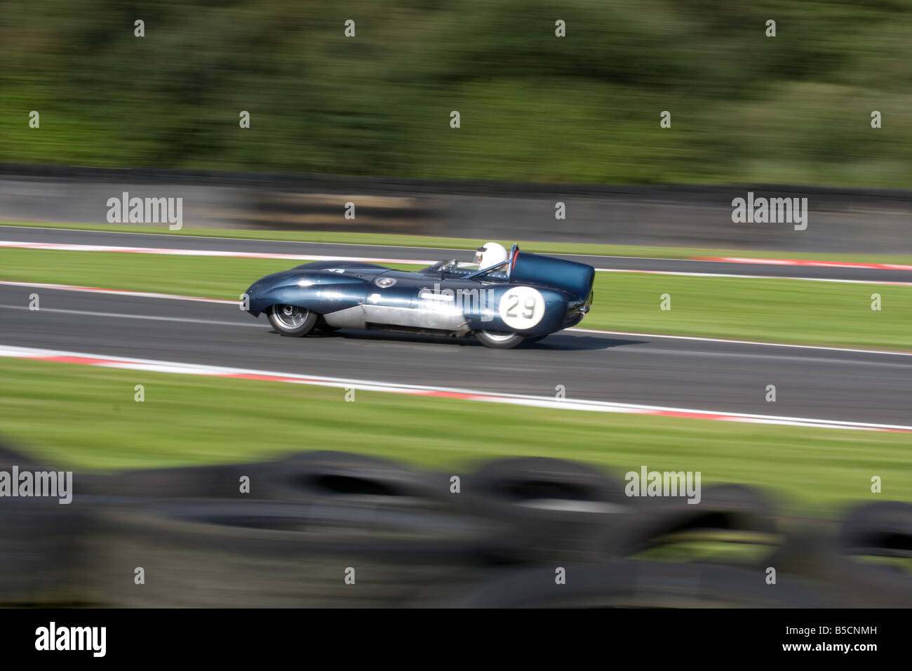 A slow shutter speed panning shot of an old classic car at Oulton Park in Cheshire in the UK. Stock Photo