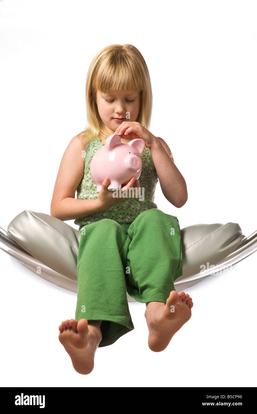 Young girl holding a piggy bank isolated on white Stock Photo - Alamy