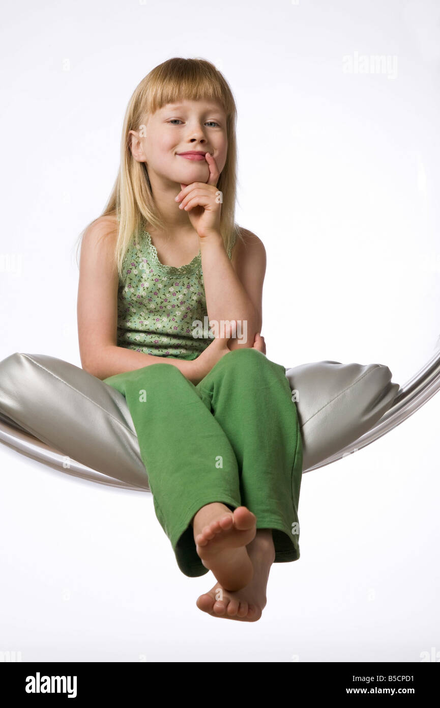 Portrait of a young girl against white background Stock Photo - Alamy