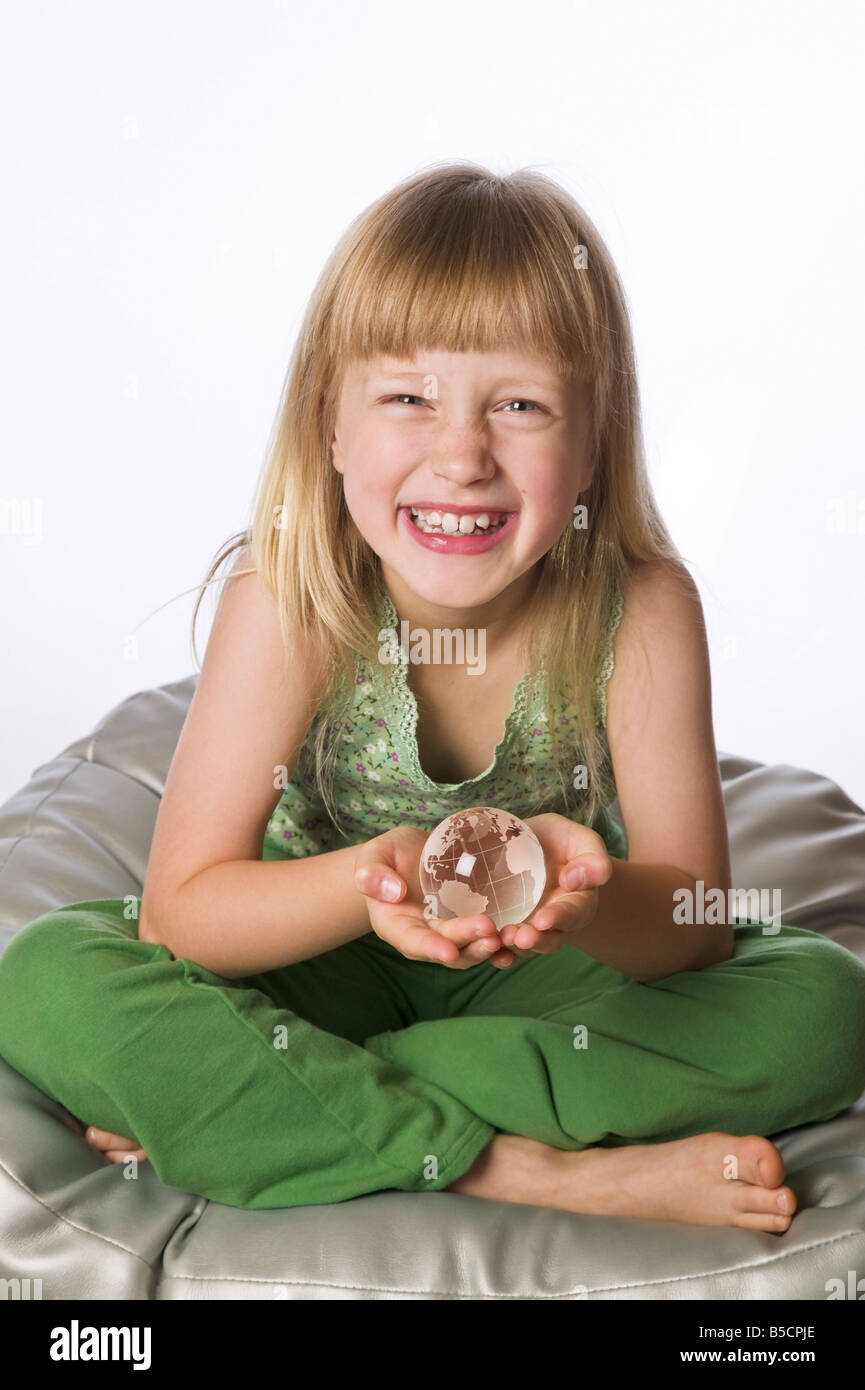 Young girl holding a small glass globe Stock Photo Alamy