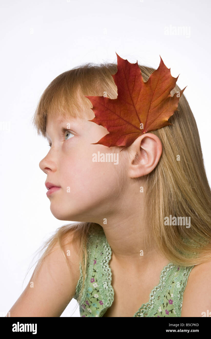 Girl wearing a autumn maple leaf behind her ear Stock Photo - Alamy