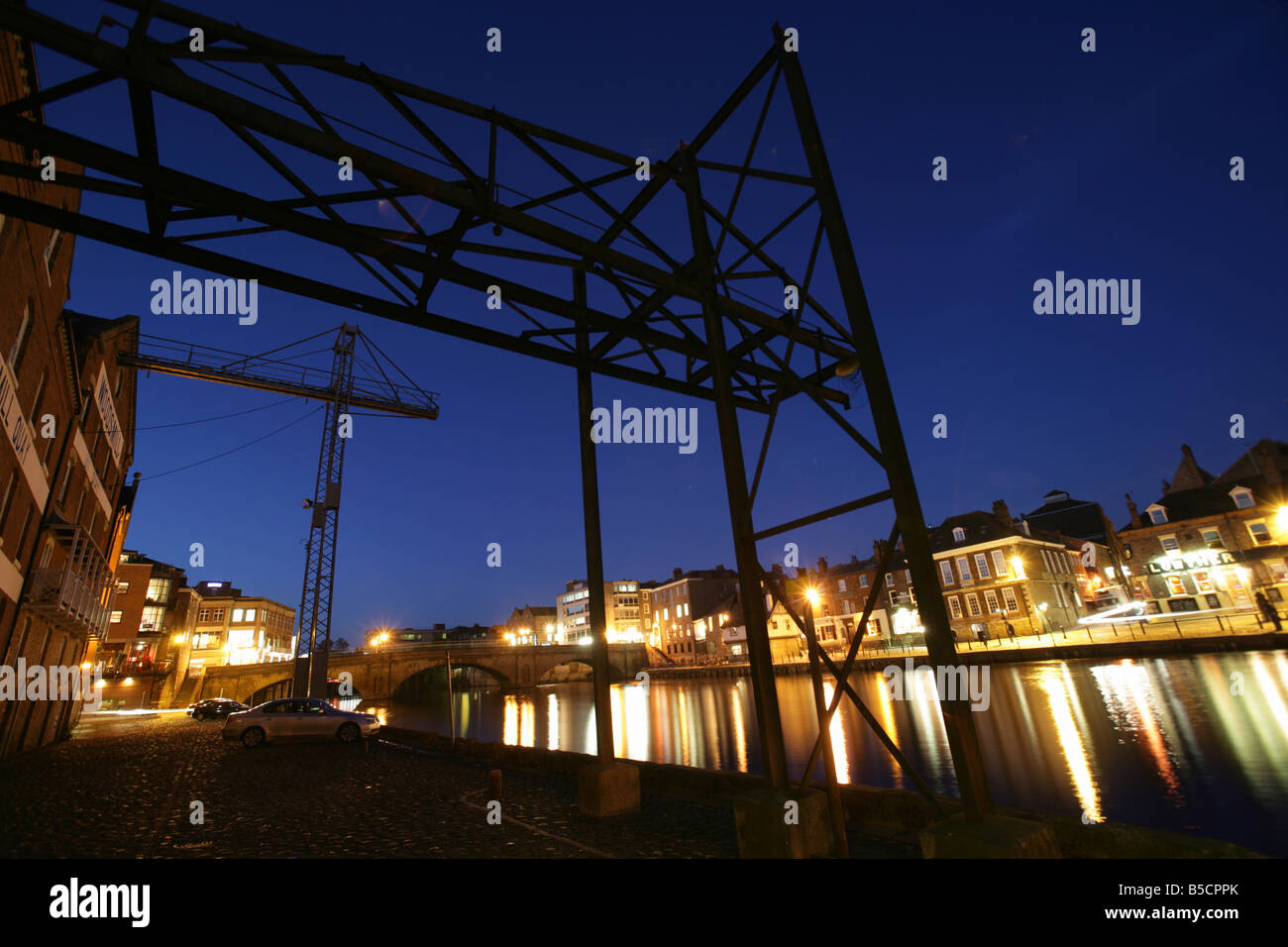City of York, England. Woodsmill Quay cranes at Queen’s Staith with the River Ouse, Ouse Bridge and King’s Staith. Stock Photo