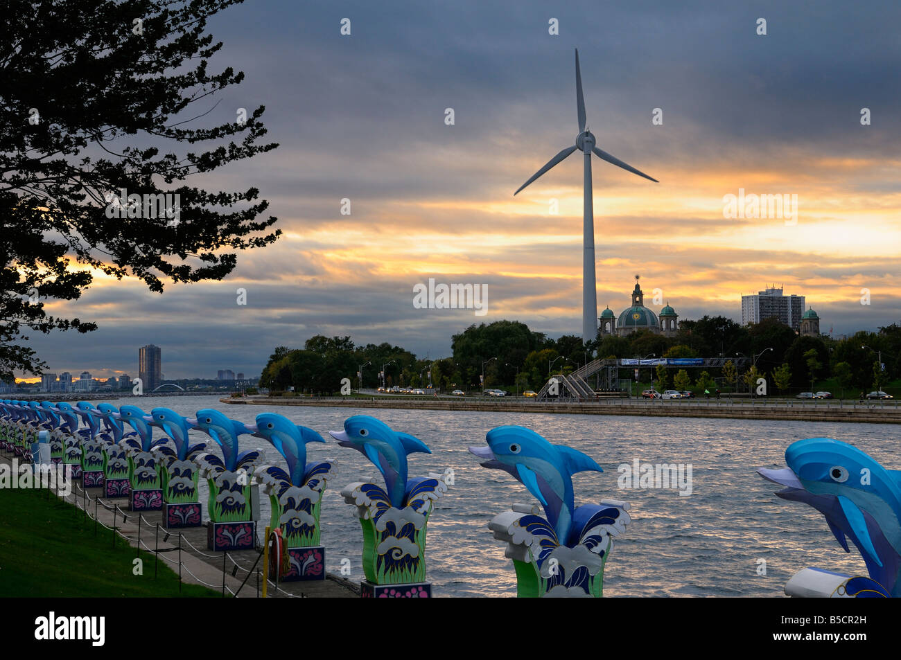 Toronto skyline at dusk with wind turbine and blue dolphins from Ontario Place Stock Photo