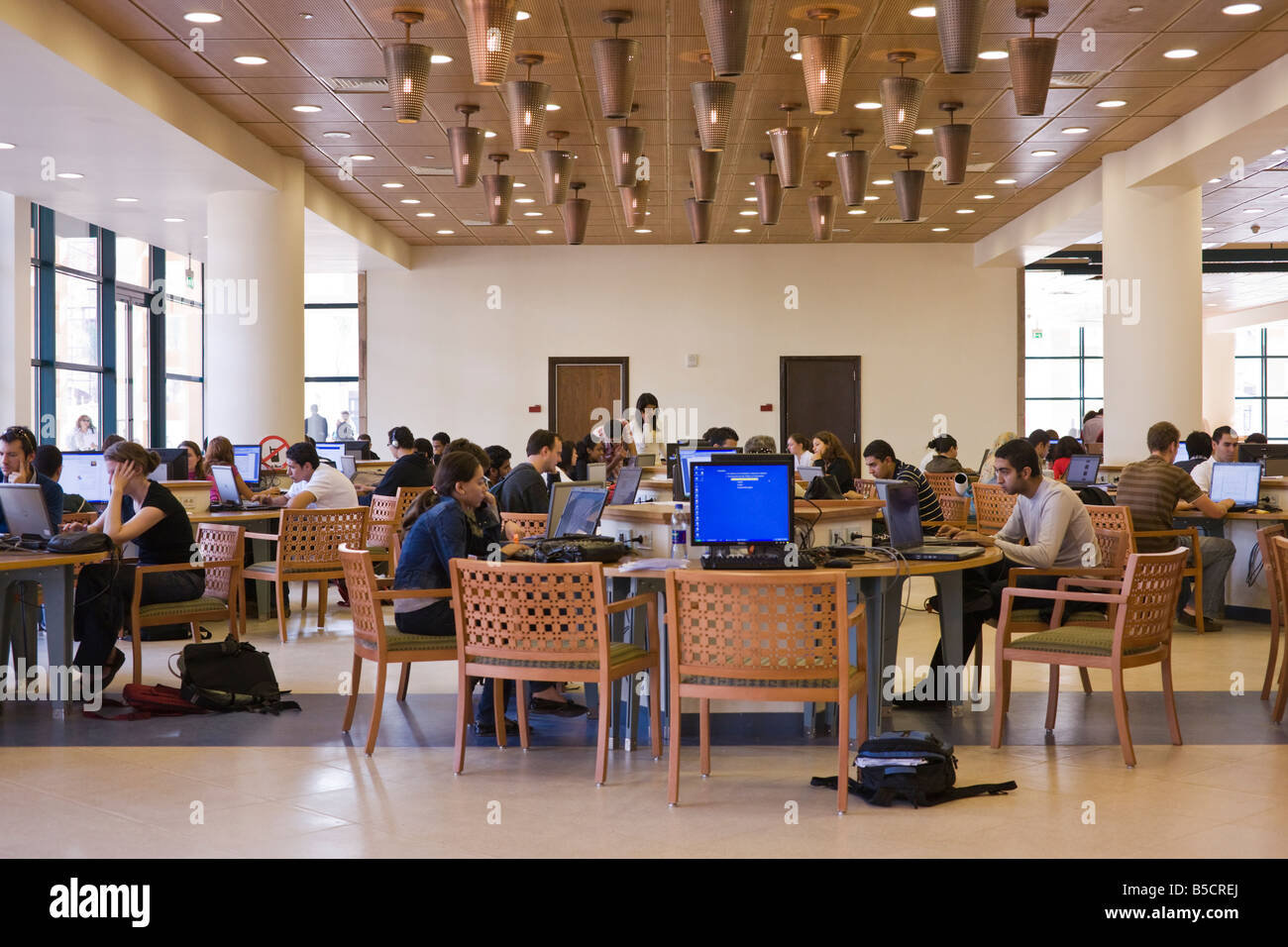 students at computer desks in library, new campus, American University