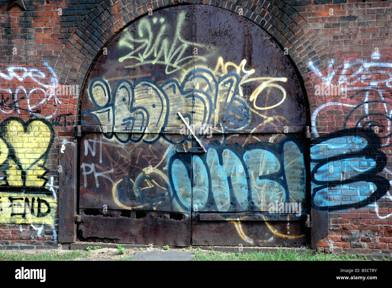 graffiti on metal doors and brick walls in dumbo brooklyn new york Stock Photo