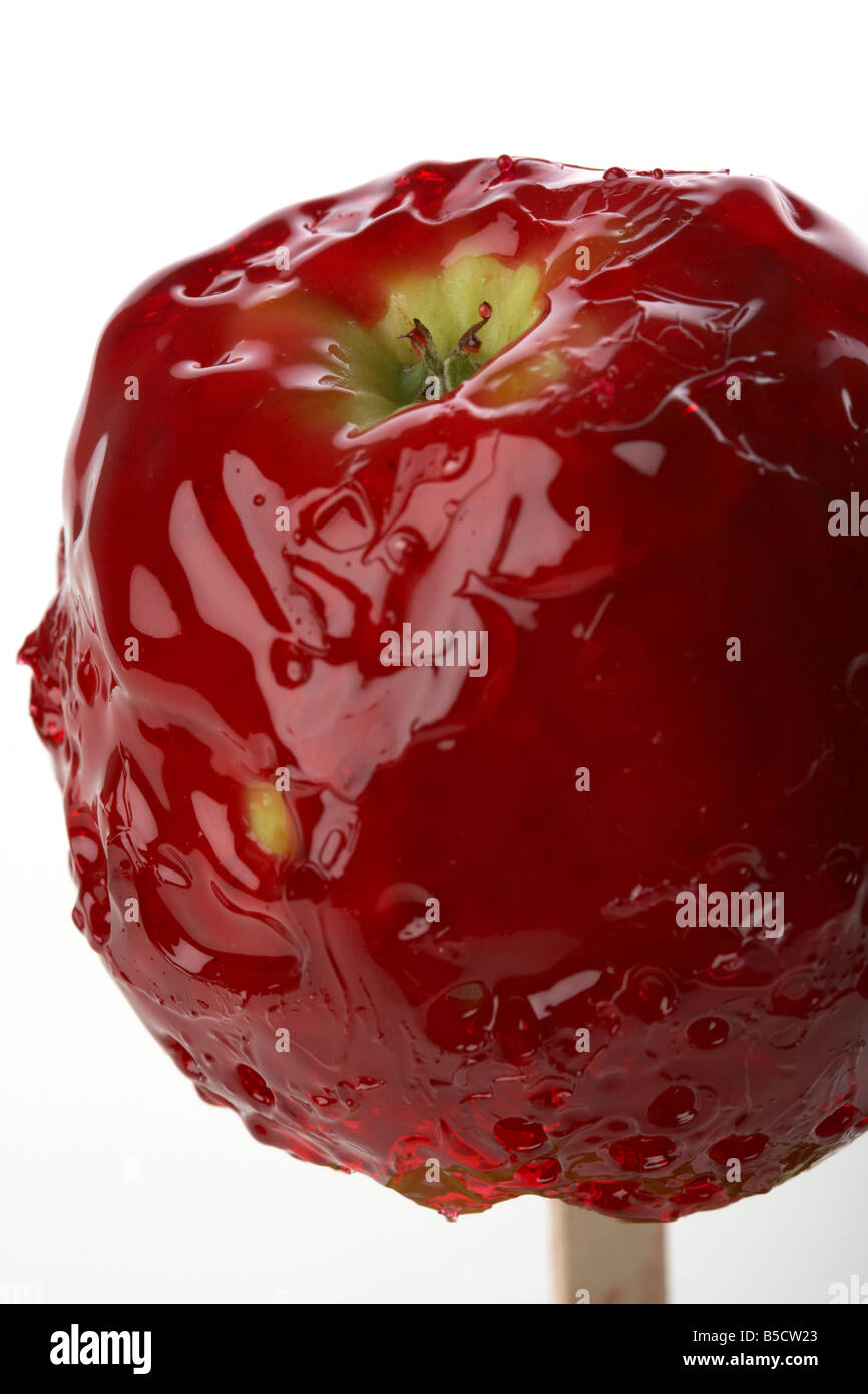candy apple covered in dripping red candy traditionally eaten in ireland at Halloween Stock Photo