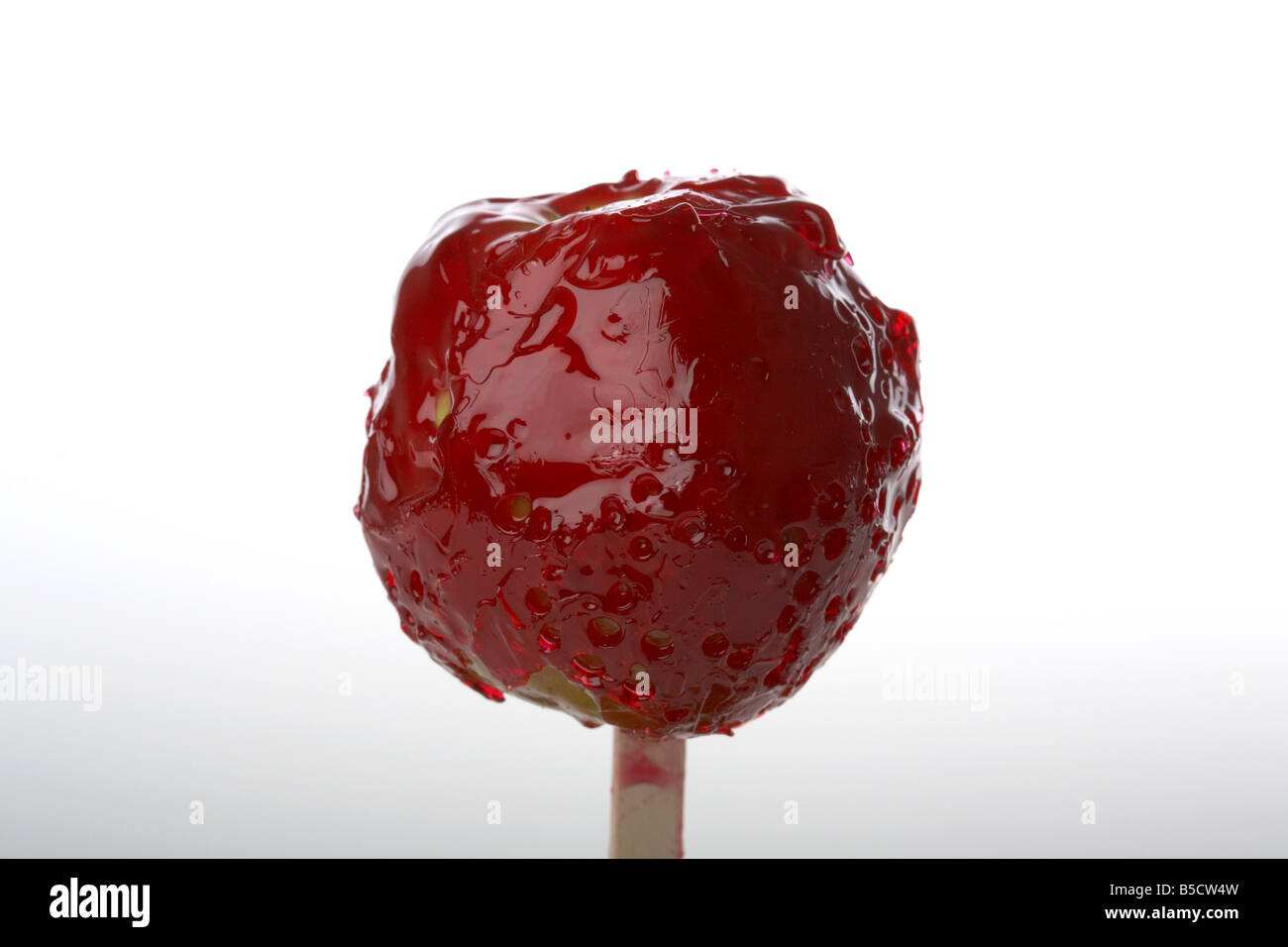 candy apple covered in dripping red candy traditionally eaten in ireland at Halloween Stock Photo