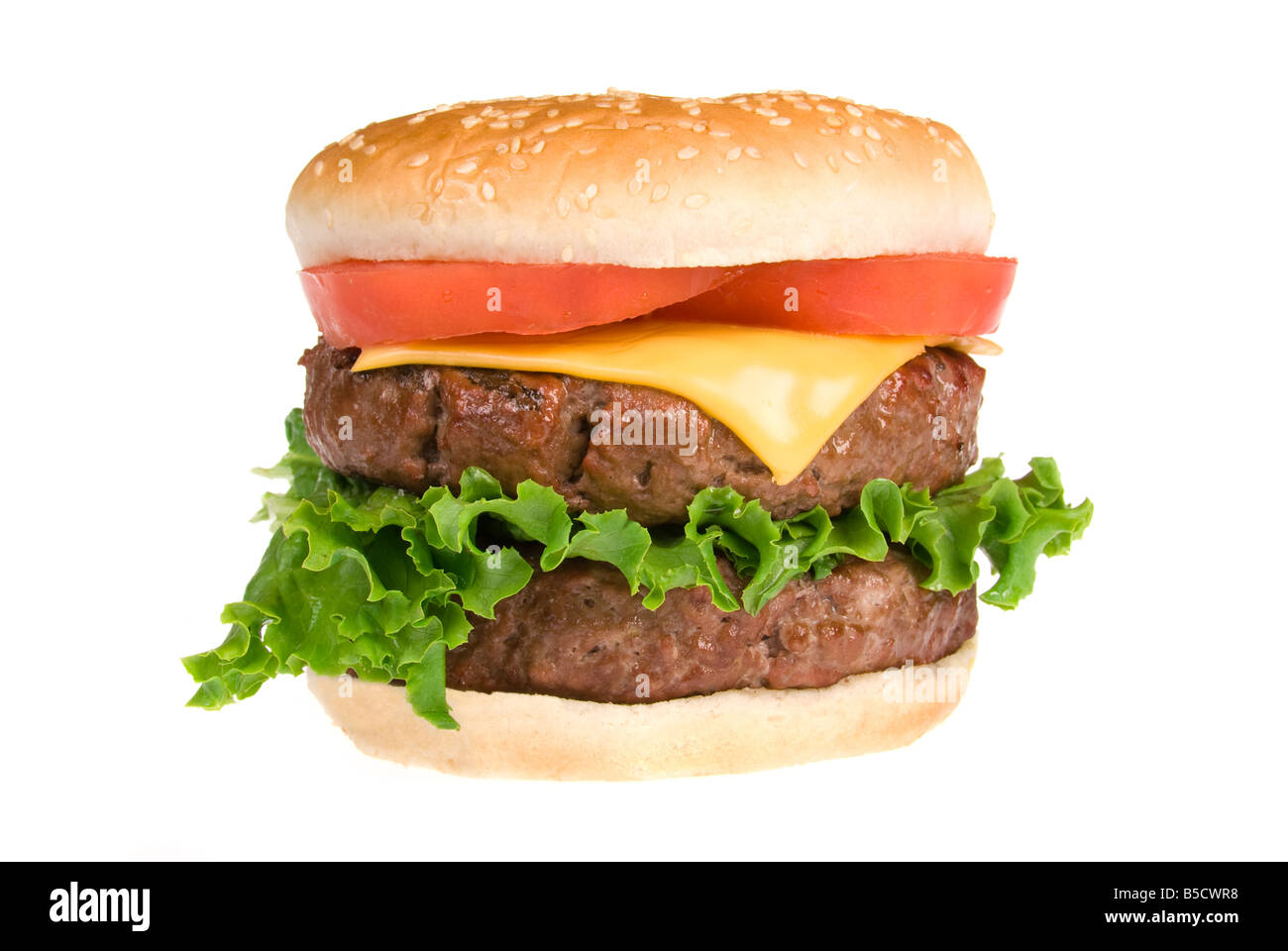 A thick fresh and juicy hamburger with all the trimmings isolated on ...